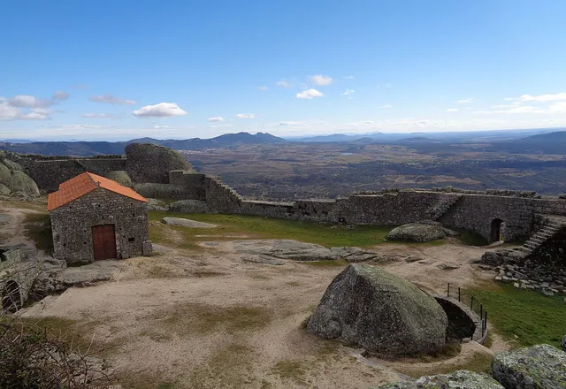 Ruins of Monsanto castle among huge granite boulders, overlooking the plain